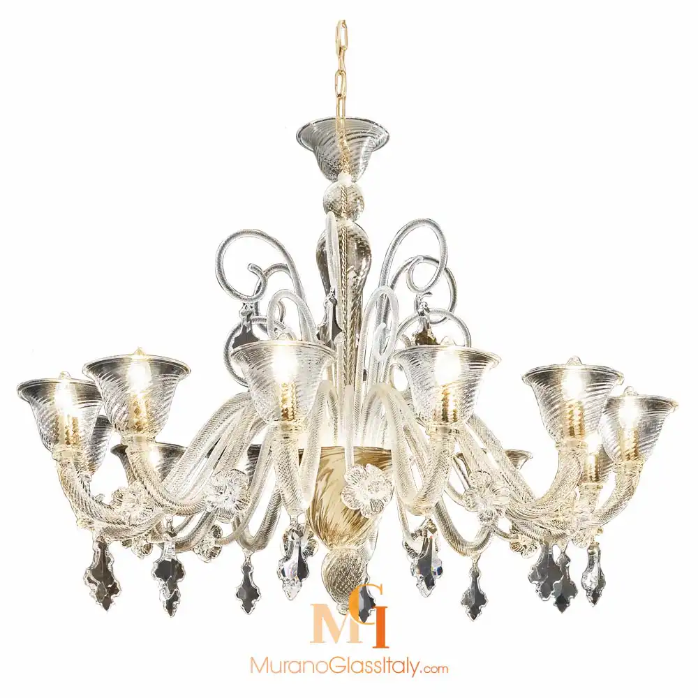 Alvise – Venetian Style Chandelier – 12L – Gold Venetian style chandelier made of Murano glass, featuring curved arms, flared patterned glass cups, gold-infused details, swirling accents, and hanging crystal pendants.