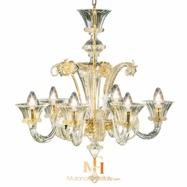 Art glass chandelier with eight clear twisted upward arms, infused with gold, flared glass cups, and decorative floral accents around the center.