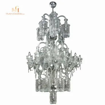 Crystal chandelier with intricate hand-blown glass arms and cascading fringe-like details, featuring a tall, sculptural multi-tiered design.